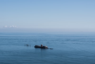 Blue ocean brown wooden pier during the day
